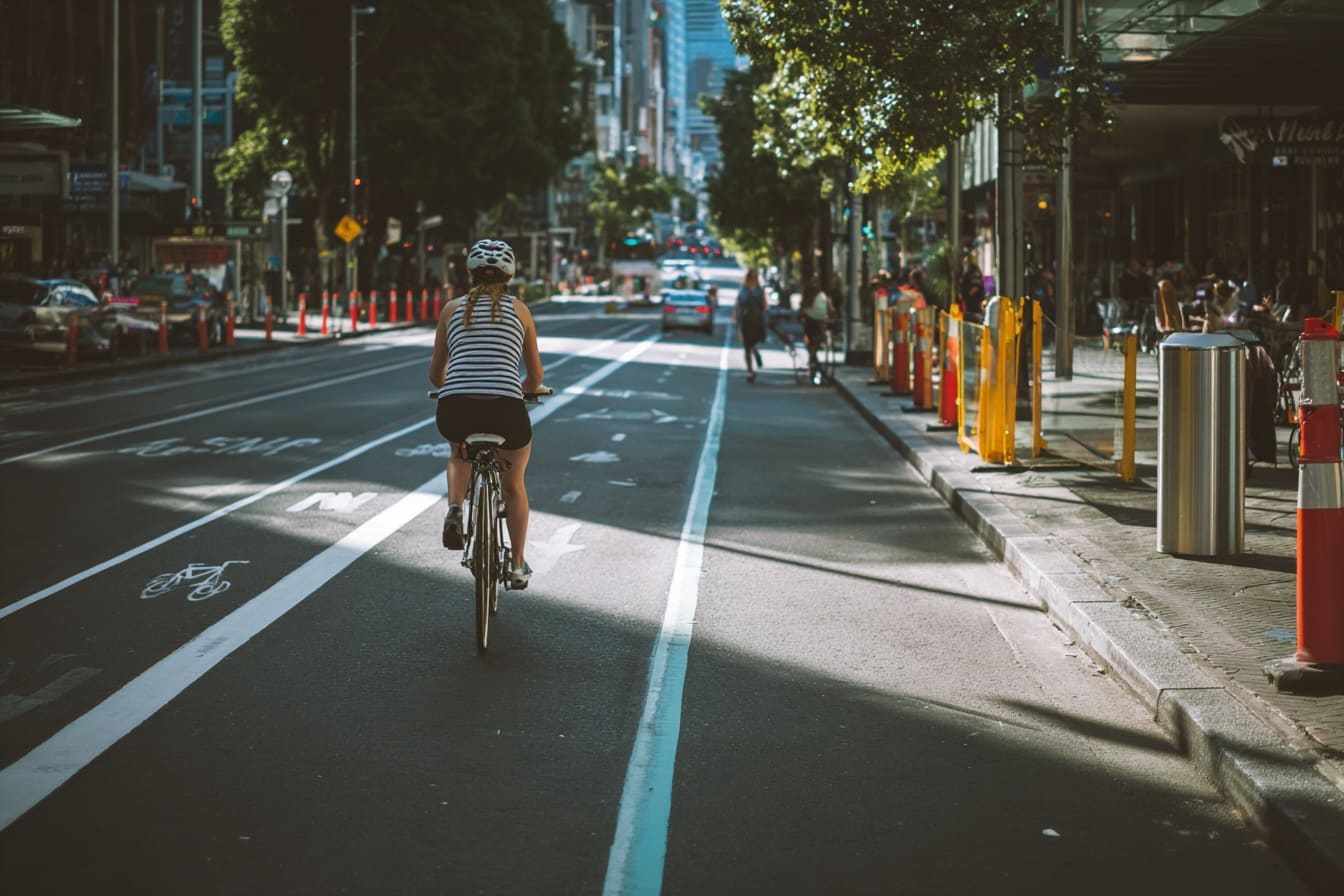 Modern separated bike lane with female cyclist in Australian city