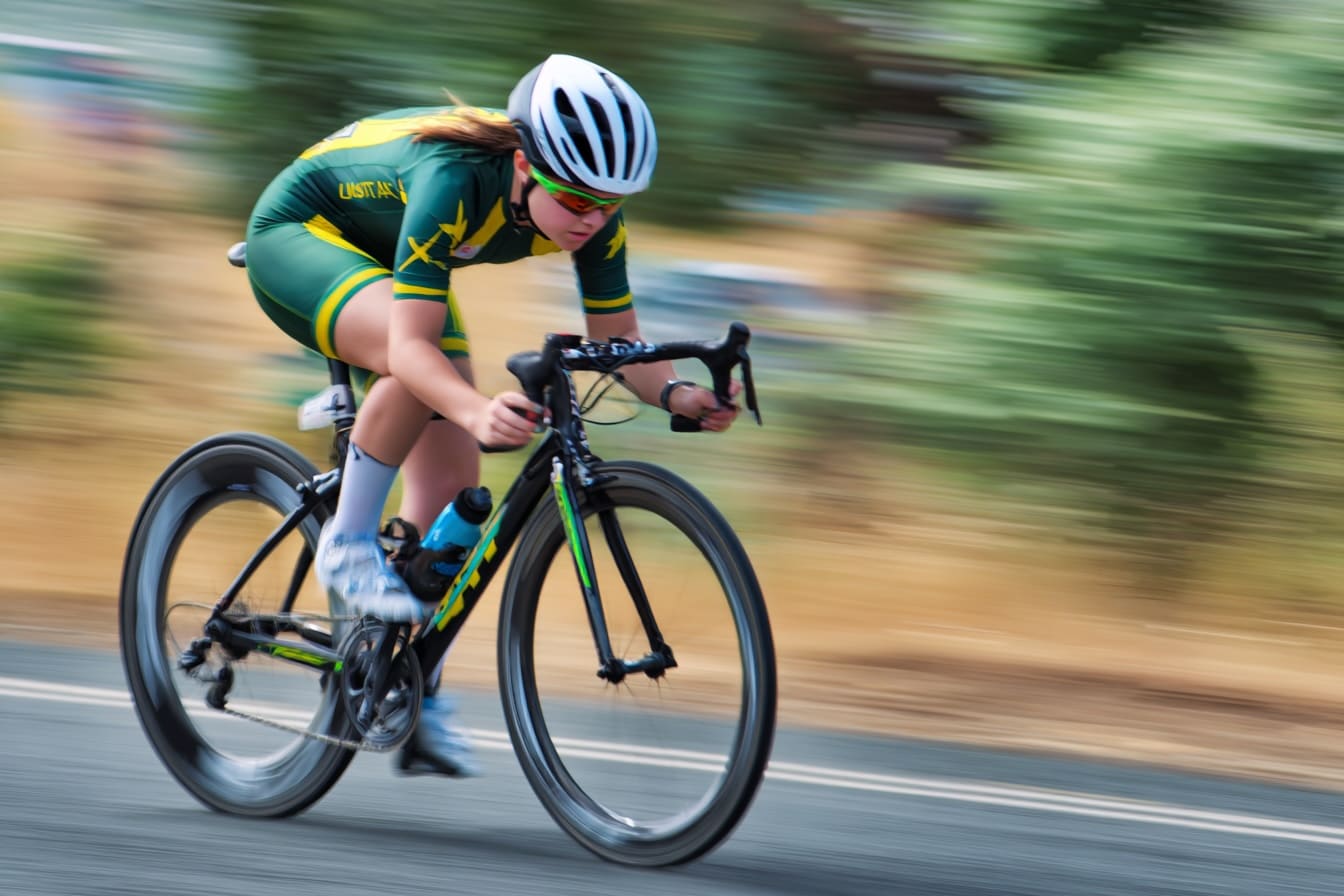 Professional female cyclist racing in Australian national colors
